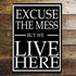 Excuse The Mess But We Live Here - Metal Humour Wall Sign